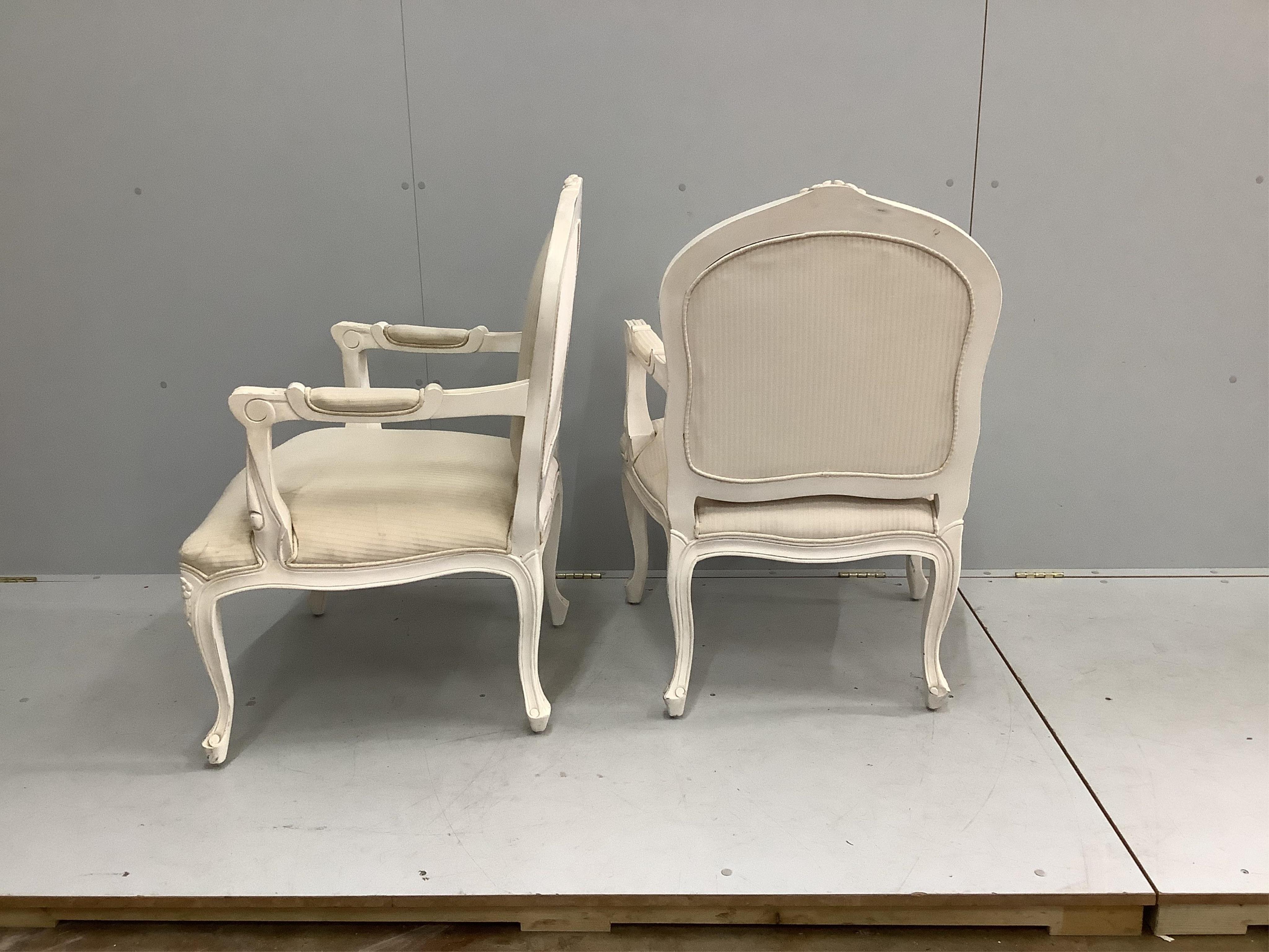 A pair of Louis XV style cream painted fauteuil, width 66cm, depth 60cm, height 94cm. Condition - fair